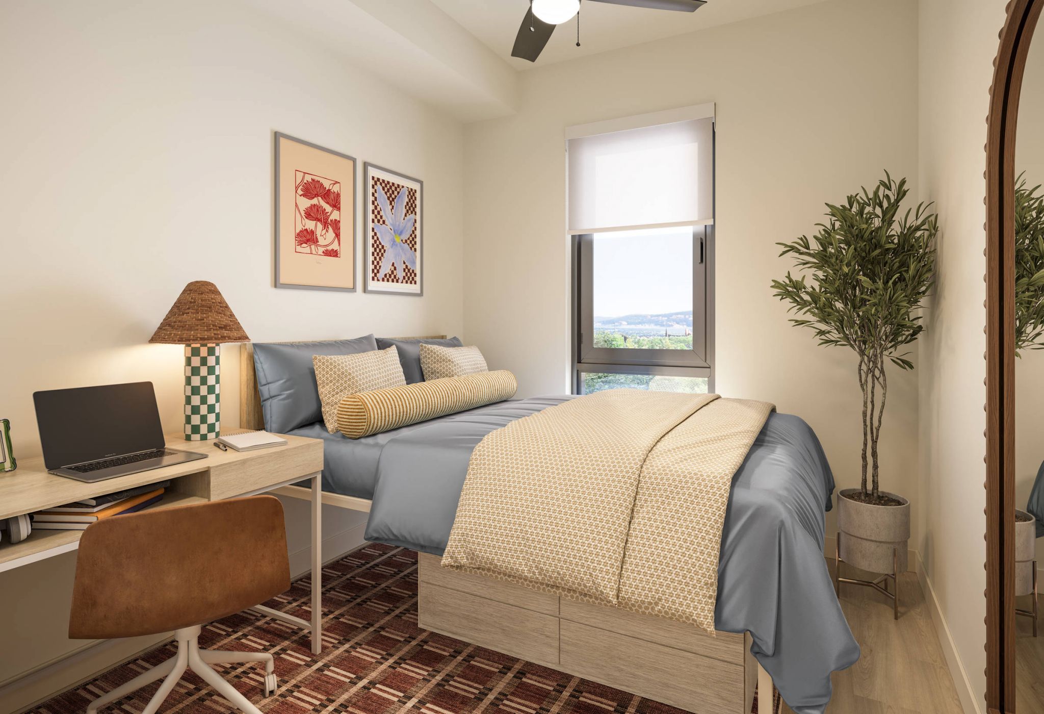 A cozy bedroom with a bed, desk, chair, potted plant, wall art, window, and a large mirror.