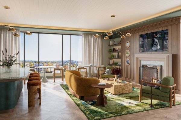 Modern living room with large windows, stylish furniture, green accents, and decorative wall plates.